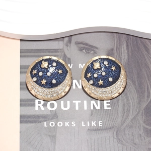 Deep blue enamel moon and star stud earrings with sparkling crystals for a galaxy look