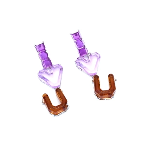Retro purple resin heart drop earrings with bold orange U-shaped charms on white background