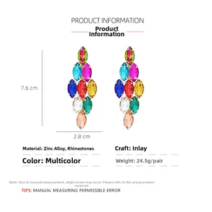 Macro detail of multicolored rhinestone earrings with dimensions 7.6cm by 2.8cm