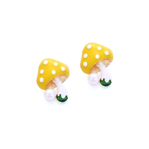 Detail of mushroom earrings featuring yellow enamel polka dots and white faux pearls