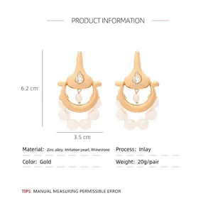 French vintage gold earrings with faux pearls and rhinestones on white background