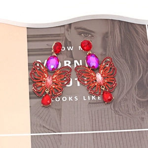 Luxurious butterfly drop earrings with red and purple crystals on a gold alloy base