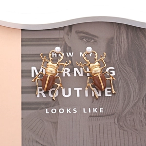 Retro beetle earrings in gold and brown enamel with white pearl drop accent