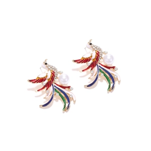 Detailed macro view of colorful enamel phoenix earrings with rhinestones and faux pearl