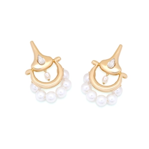 Detail of vintage gold alloy earrings with pearls and a teardrop crystal accent