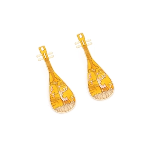 Close-up of yellow enamel pipa earrings with floral deer patterns in Chinese style