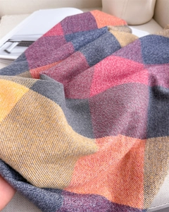 Détail macro de l'écharpe à carreaux multicolores avec texture en tricot brossé doux