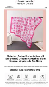 Close-up of pink shell print silk scarf showing smooth satin texture and hand-rolled edges