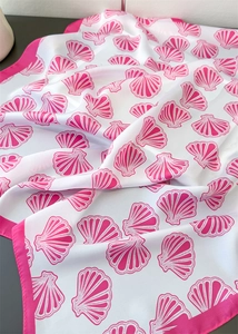 Detail view of pink seashell print silk scarf with satin luster and deep pink hem