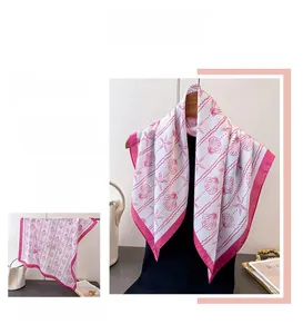 Detail of silk-like square scarf featuring pink seashell and starfish ocean prints