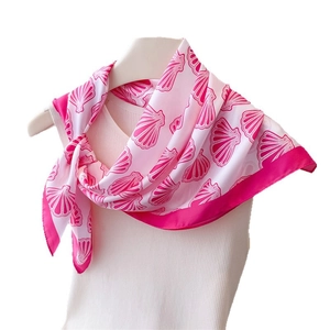 Fresh ocean shell print faux silk square scarf in rose pink and white worn on neck