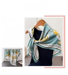 Detail of elegant satin floral scarf with vintage gray-green print and striped border