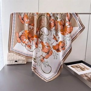 Luxurious floral satin scarf in orange and cream silk-like fabric with geometric border