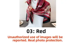 Close-up of red and black floral silk scarf tied elegantly around a woman's neck