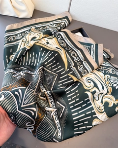 Detail showing the luxurious satin texture and elegant vintage pattern of the square scarf