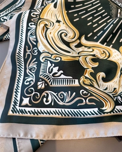 Close-up of baroque floral print and glossy silk texture on the elegant square scarf