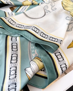 Detail of premium satin silk scarf featuring floral prints and smooth texture