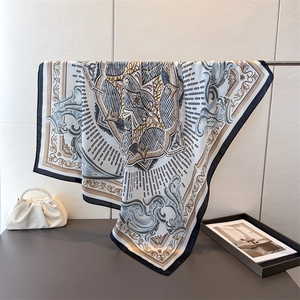 Elegant satin square scarf featuring ivory silk texture and navy blue baroque horse print