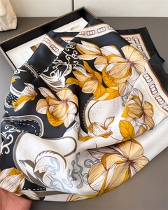Detail of satin floral silk scarf with smooth texture and elegant patterns