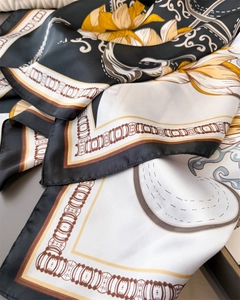 Detail of satin floral scarf showing smooth texture and vintage yellow flower print