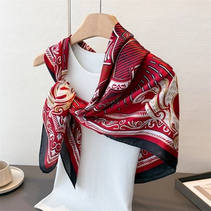Detail view of satin square scarf with red baroque prints styled on a white top