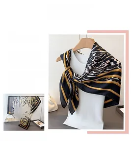 Detail of leopard print silk scarf with golden chain patterns for women as a neck wrap