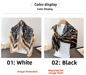 Detail of leopard print satin scarves in white and black with gold chain borders