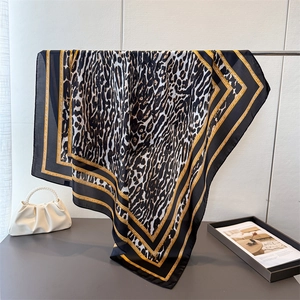 Elegant leopard print satin square silk scarf with gold and black geometric border pattern