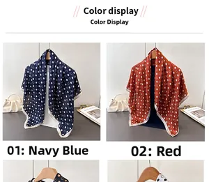 Detailed comparison of navy blue and red polka dot silk scarves hanging on wooden hangers