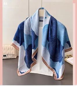 Detail of elegant floral satin scarf with blue abstract patterns on a display stand