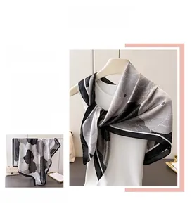 Detail of elegant floral satin scarf with abstract black and white silk texture patterns