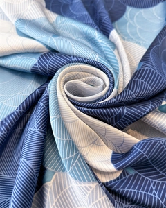 Macro detail of elegant floral satin scarf featuring silky geometric blue vein patterns