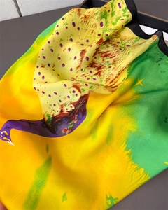 Macro detail of satin peacock feather print scarf showing smooth glossy texture