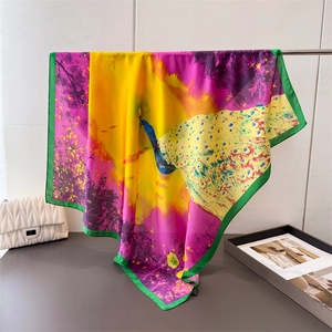 Elegant peacock print silk scarf in yellow and purple with smooth satin texture