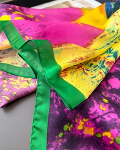 Detailed close-up of vibrant peacock floral satin scarf with fine stitching and silky texture