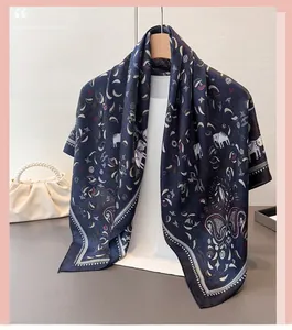 Detailed pattern view of a navy blue satin scarf with ethnic elephant and paisley prints