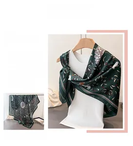 Detail of satin silk scarf with vintage green prints and premium hemmed edge texture