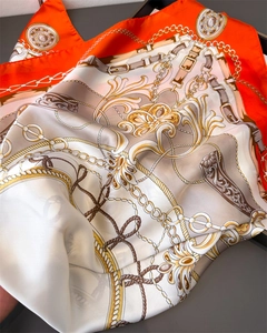 Detail of luxury satin scarf featuring vintage chain patterns and elegant floral motifs