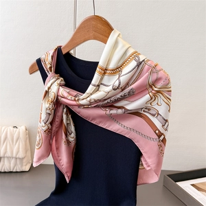 Detailed view of luxury satin square scarf with pink gold chain and belt print design