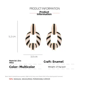 Detail view of oval checkered earrings showing 5.2cm height and 3.0cm width dimensions
