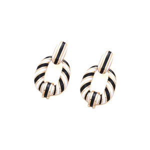 Elegant gold earrings with black and white enamel spiral stripes in a geometric oval link design