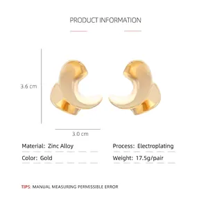Sculptural gold C-shaped twisted metal leaf earrings with a vintage polished finish