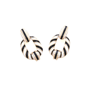 Vintage gold earrings with black and white enamel stripes in a nested geometric design