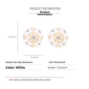 Detail showing 2.4cm white enamel snowflake stud earrings with sparkling rhinestones