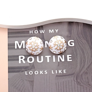 Spherical gold snowflake earrings with white enamel base and sparkling rhinestones