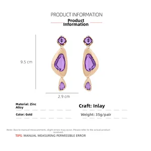 Detailed view of gold geometric drop earrings with purple stones and 9.5cm length measurements
