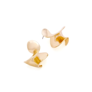 Close-up of golden metallic twisted leaf earrings with polished mirror finish surface