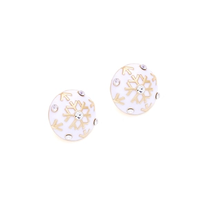 Detailed close-up of white enamel snowflake earrings with gold plating and crystals