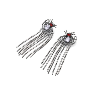 Vintage spider fringe earrings with rhinestones and red gems on a white background