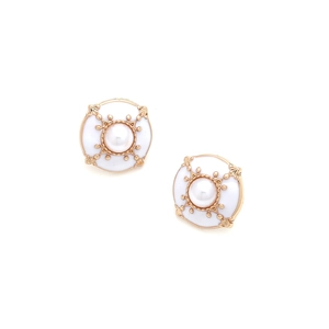 Detail of round vintage button earrings with gold metal base white enamel and pearl inlay
